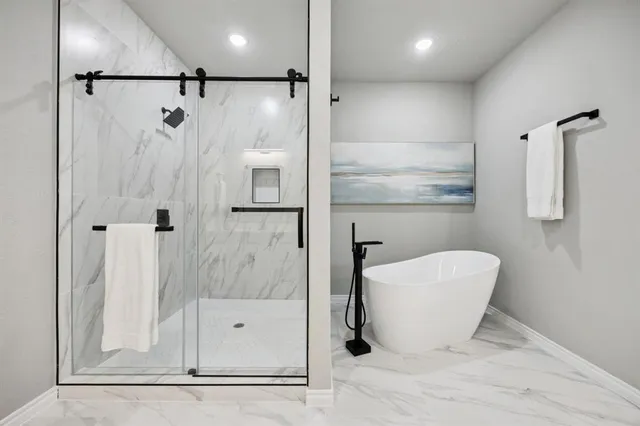 a bathroom with a bathtub and a shower