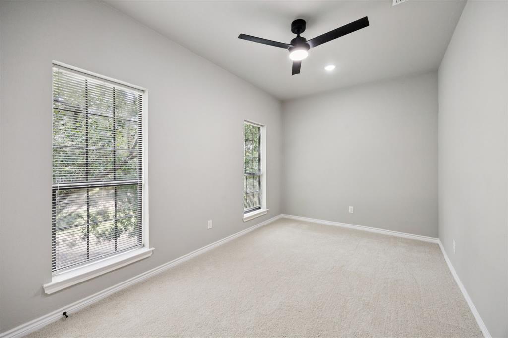 10 Chisholm Trail Lucas, TX 75002 - Photo 20 of 40 an empty room with a ceiling fan and windows
