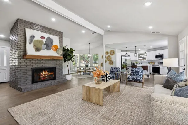 a living room with furniture a fireplace and a fireplace