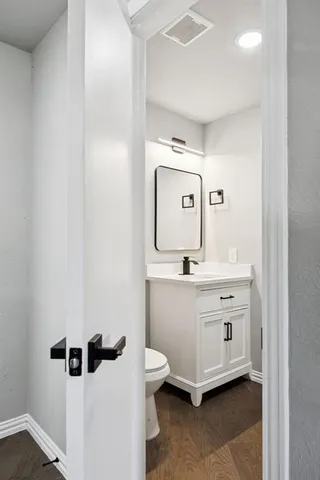 a bathroom with a sink a toilet and mirror