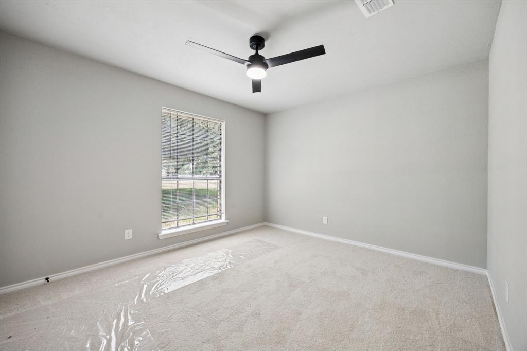 10 Chisholm Trail Lucas, TX 75002 - Photo 22 of 40 an empty room with ceiling fan and windows