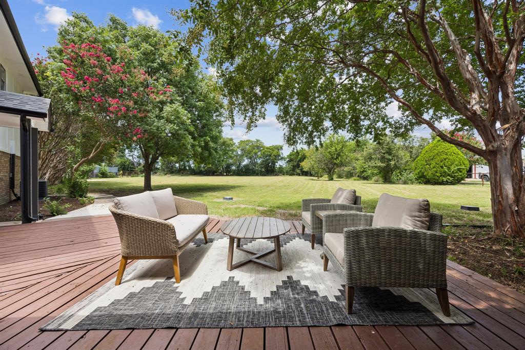 10 Chisholm Trail Lucas, TX 75002 - Photo 32 of 40 a view of a patio with table and chairs and couches with wooden floor and fence