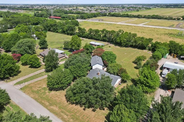 an aerial view of ocean with residential house with outdoor space and river