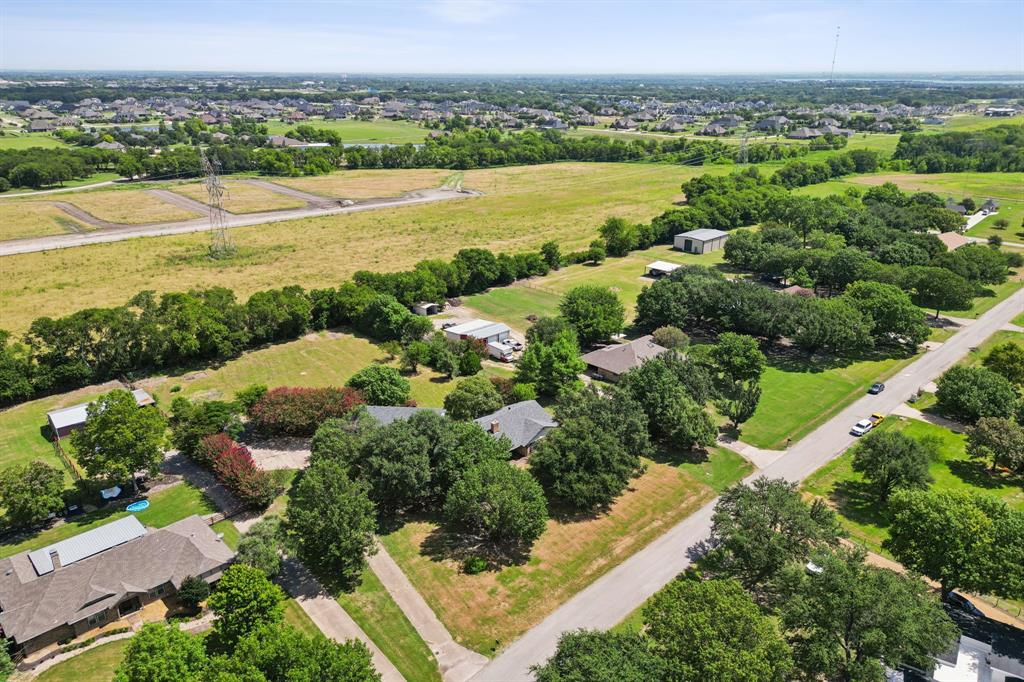 10 Chisholm Trail Lucas, TX 75002 - Photo 38 of 40 an aerial view of green landscape with trees houses and lake view