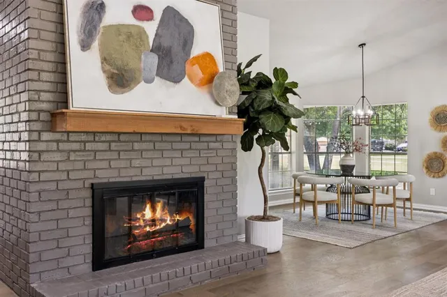 a living room with couches chairs and a fireplace