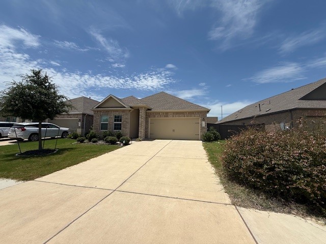 1745 Woolsey Way Leander, TX 78641 - Photo 2 of 20 a front view of a house with a garden and yard