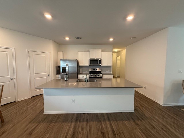1745 Woolsey Way Leander, TX 78641 - Photo 3 of 20 a large kitchen with stainless steel appliances a large counter top a sink a stove a refrigerator and cabinets