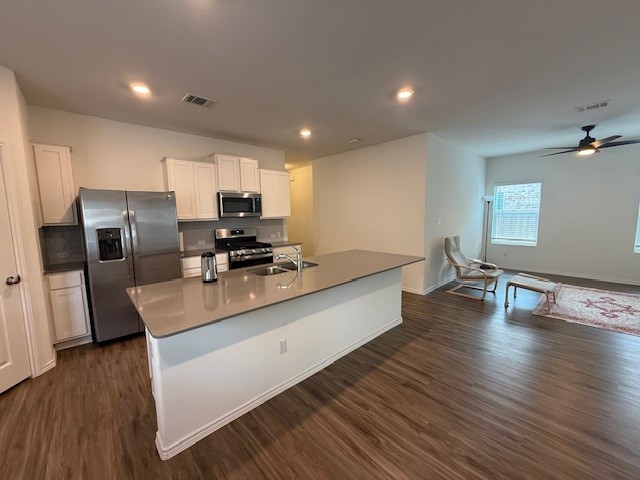 1745 Woolsey Way Leander, TX 78641 - Photo 4 of 20 a large kitchen with a large counter top stainless steel appliances and wooden floor