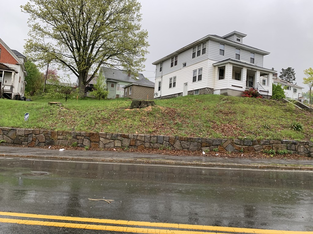 573 Grafton Street Worcester, MA 01604 - Photo 1 of 2 a front view of a house with a yard