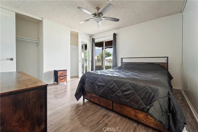 a large bed sitting in a bedroom next to a window with a chandelier