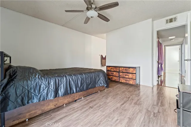 a bedroom with furniture and wooden floor