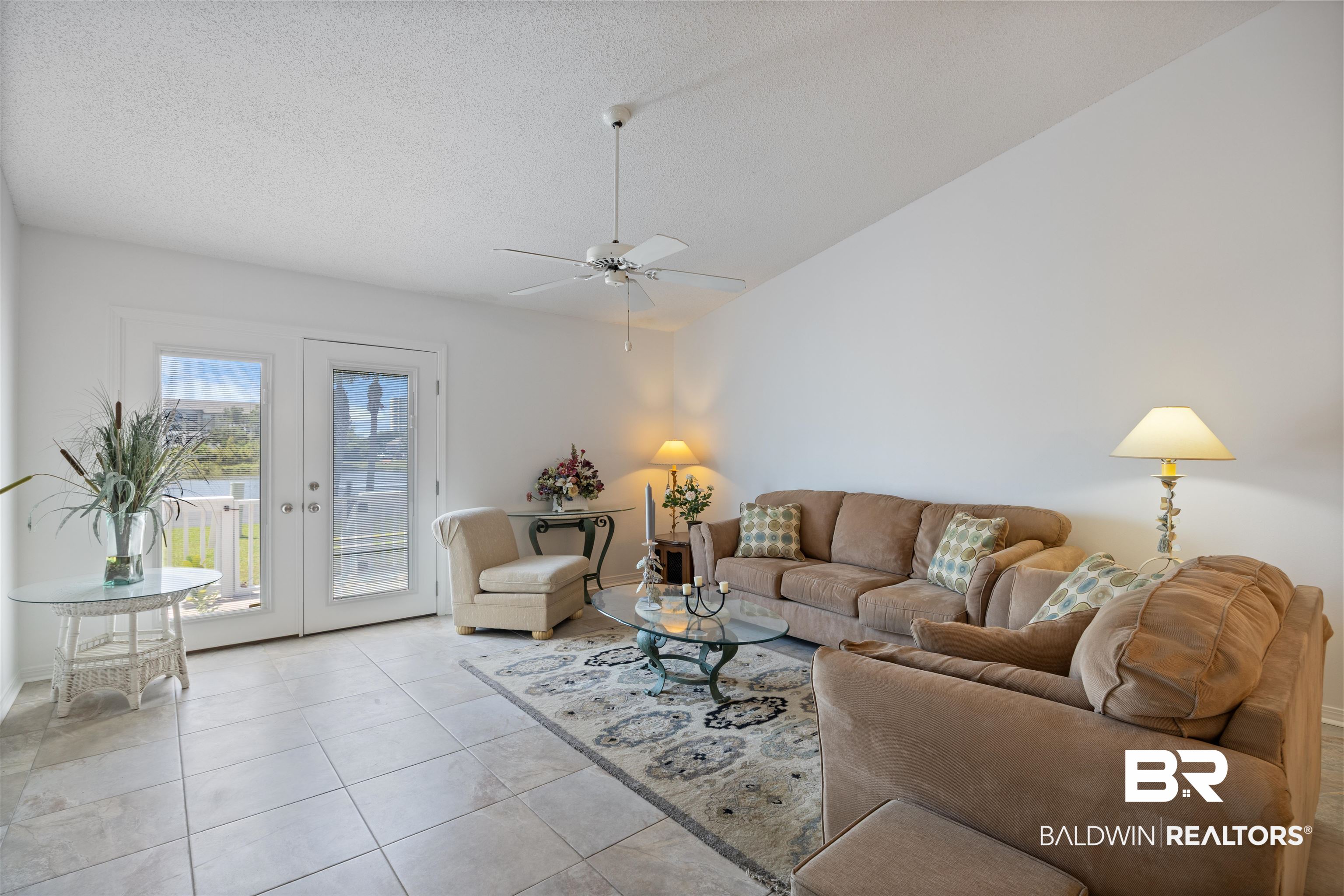 3200 Loop Road, Unit 96 Orange Beach, AL 36561 - Photo 24 of 49 Living area featuring vaulted ceilings, a ceiling fan with light, tiled flooring, and double glass-paneled doors opening to an outdoor space
