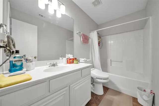 a bathroom with a sink a toilet and a large mirror