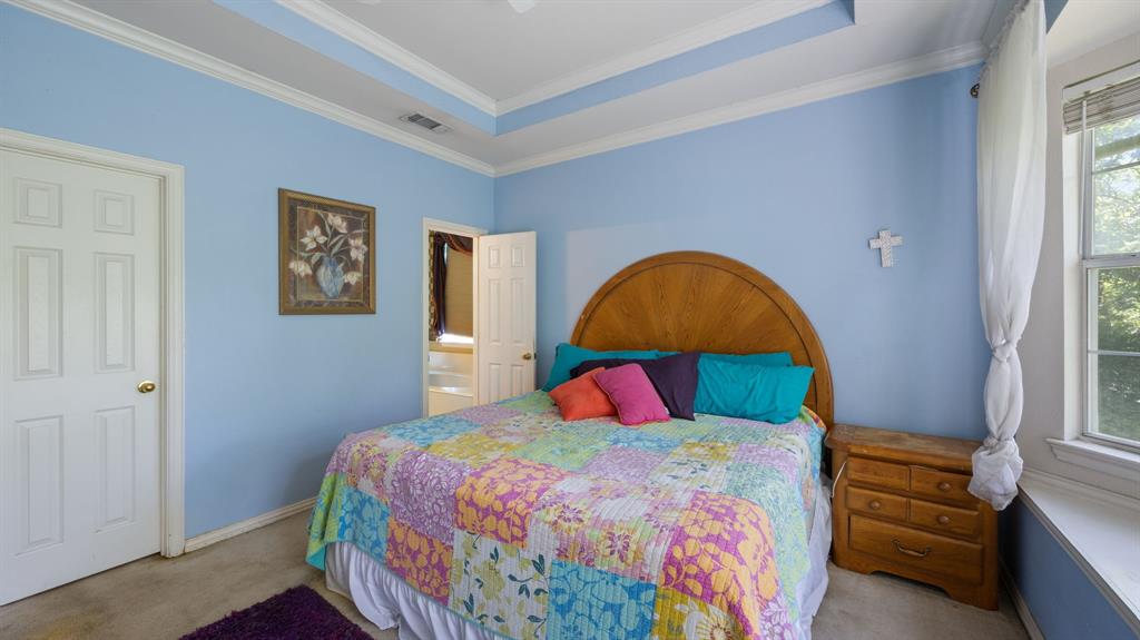 1508 Valley Creek Road Denton, TX 76205 - Photo 25 of 33 a bedroom with a bed a dresser and a window