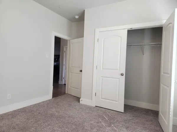 an empty room with closet area