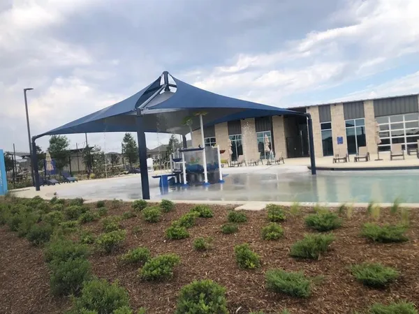 a view of a house with pool and sitting area