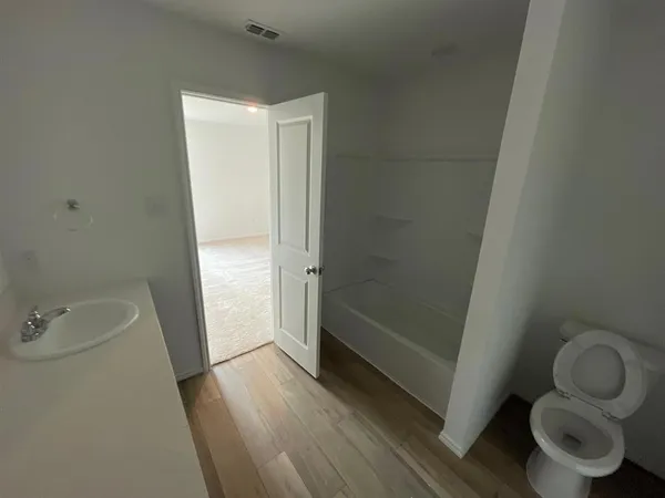 a bathroom with a tub and a shower