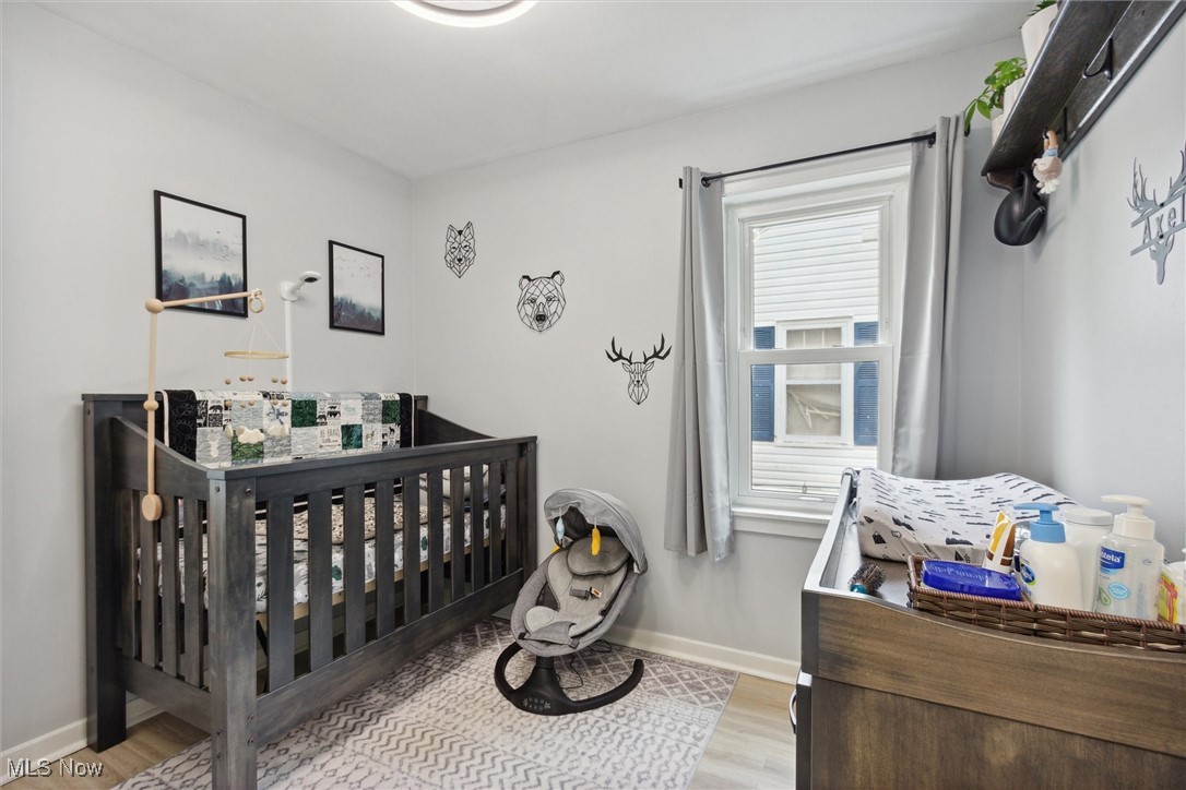 373 Erie Road Vermilion, OH 44089 - Photo 21 of 29 Bedroom with light hardwood / wood-style floors and a nursery area