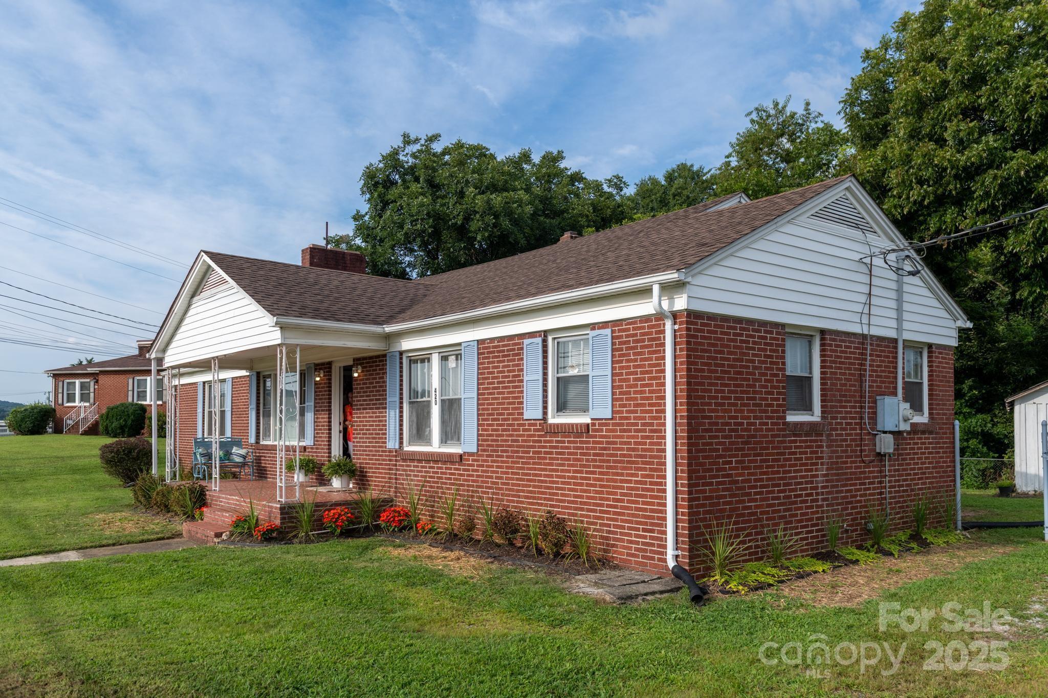 a front view of a house with a yard and green space