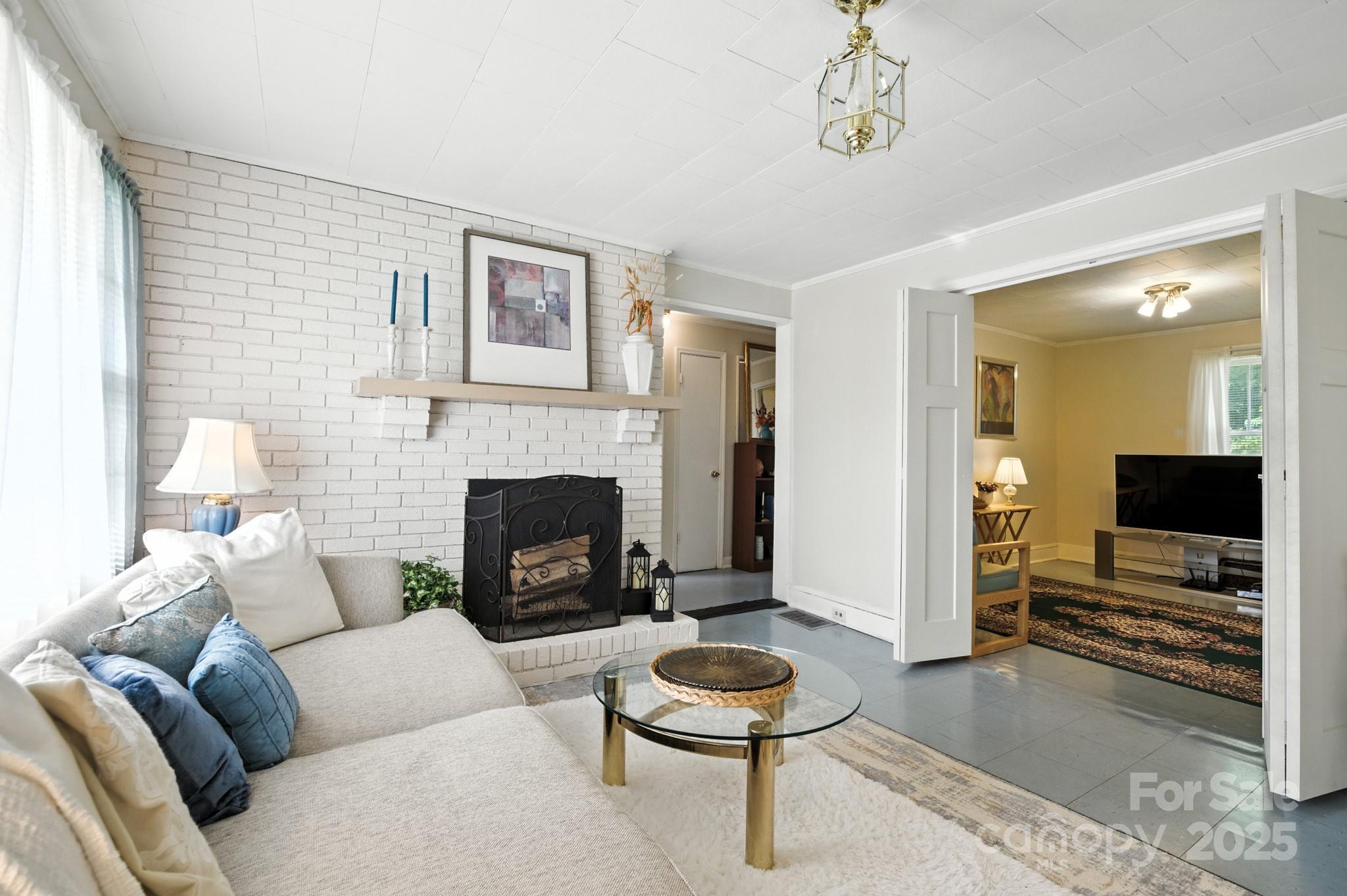 420 Virginia Street Southwest Lenoir, NC 28645 - Photo 12 of 36 a living room with furniture a flat screen tv and a fireplace