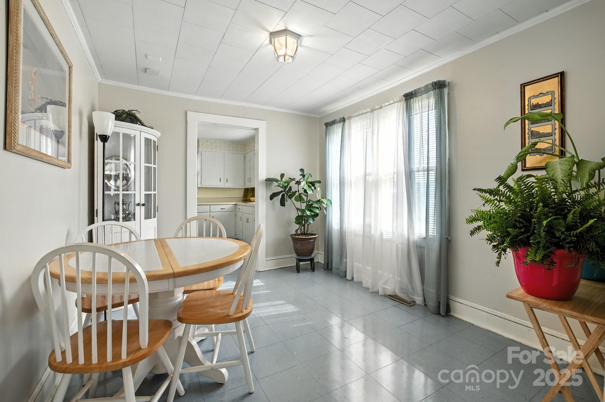 420 Virginia Street Southwest Lenoir, NC 28645 - Photo 14 of 36 a dining room with furniture potted plants and wooden floor