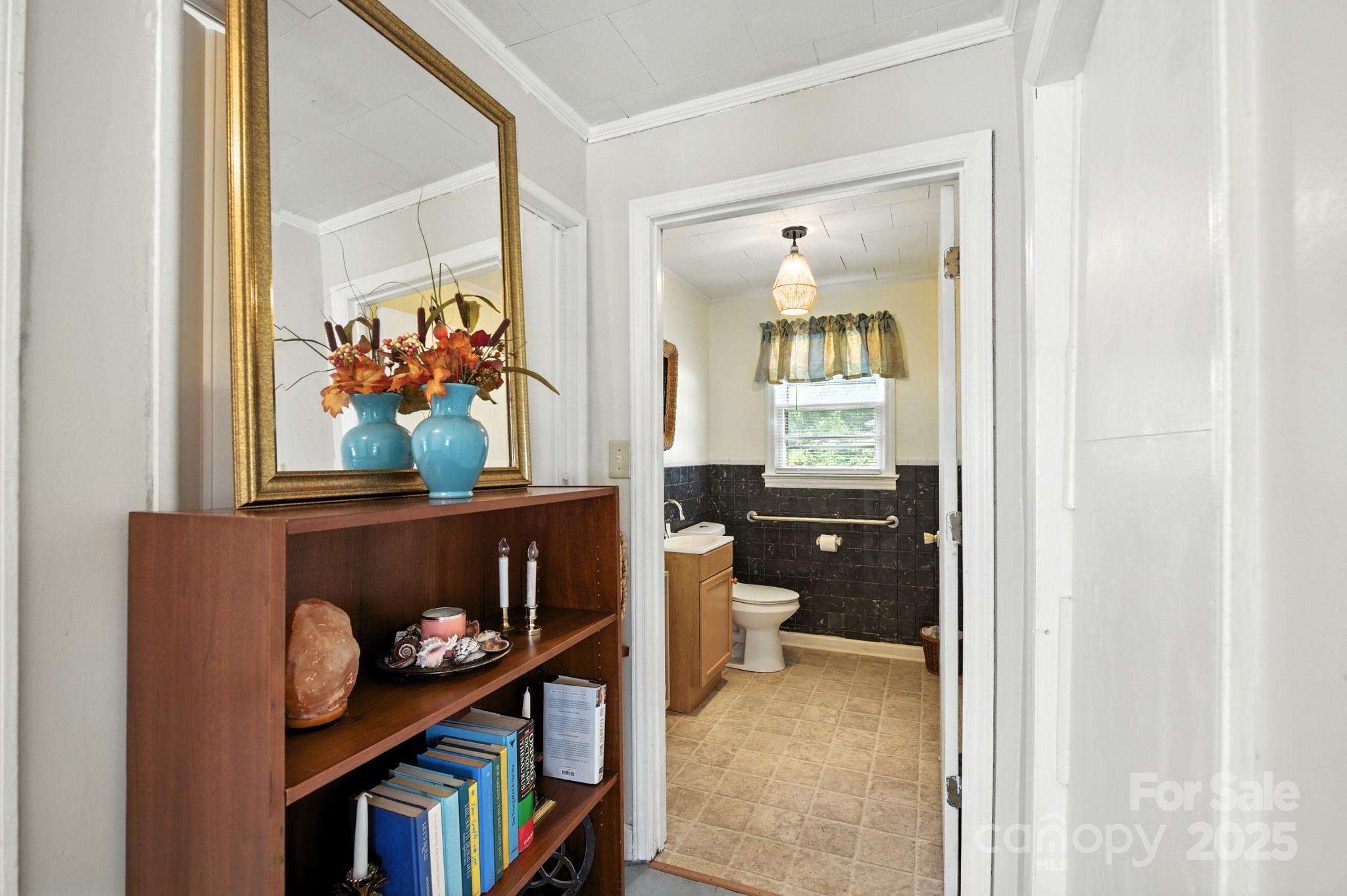 420 Virginia Street Southwest Lenoir, NC 28645 - Photo 20 of 36 a living room with painting on the wall and a potted plant