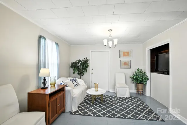 a living room with furniture and flowers