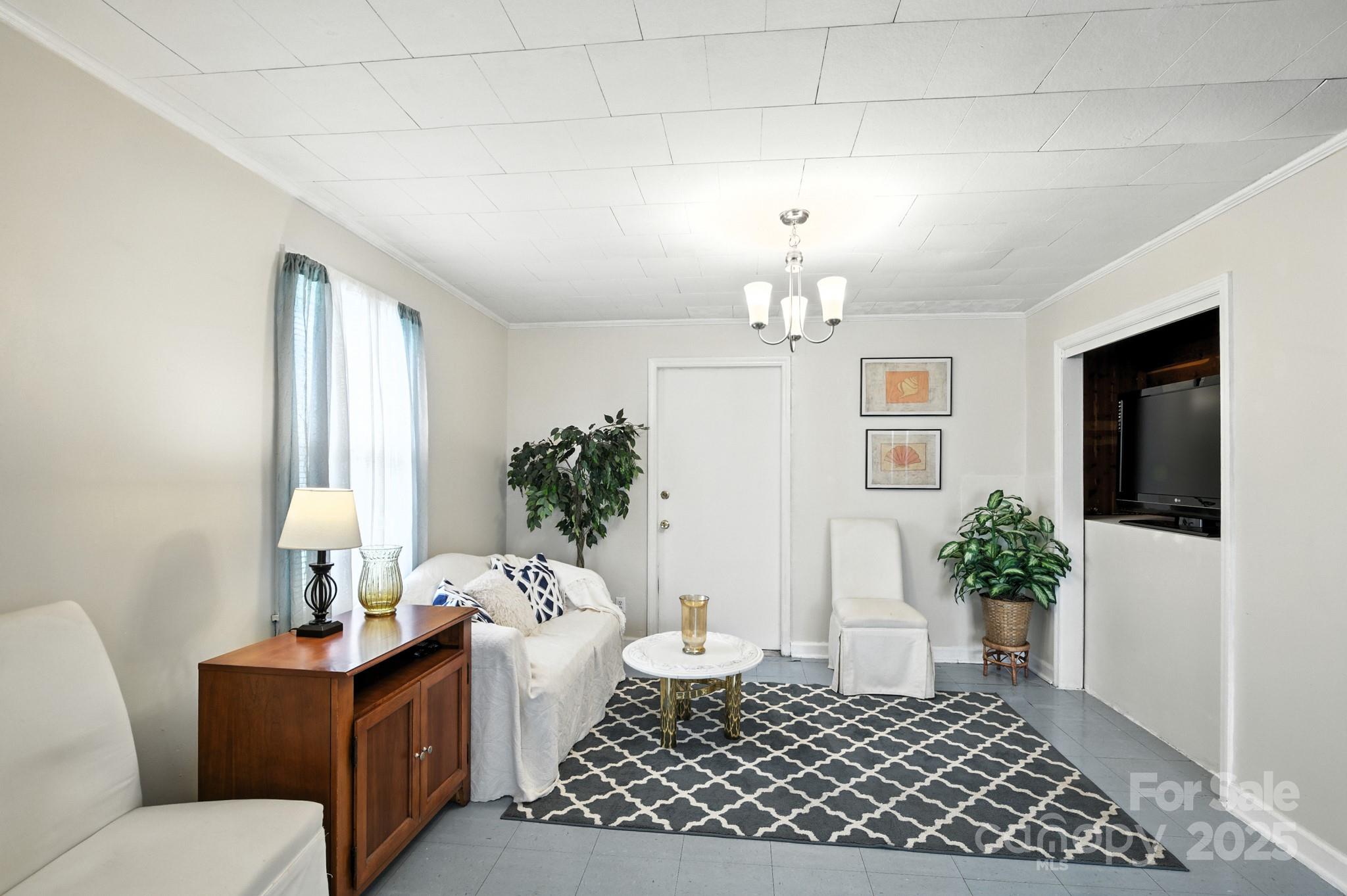 420 Virginia Street Southwest Lenoir, NC 28645 - Photo 22 of 36 a living room with furniture and a chandelier