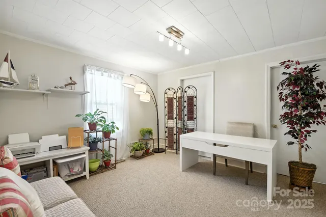 a living room with furniture and a painting on the wall