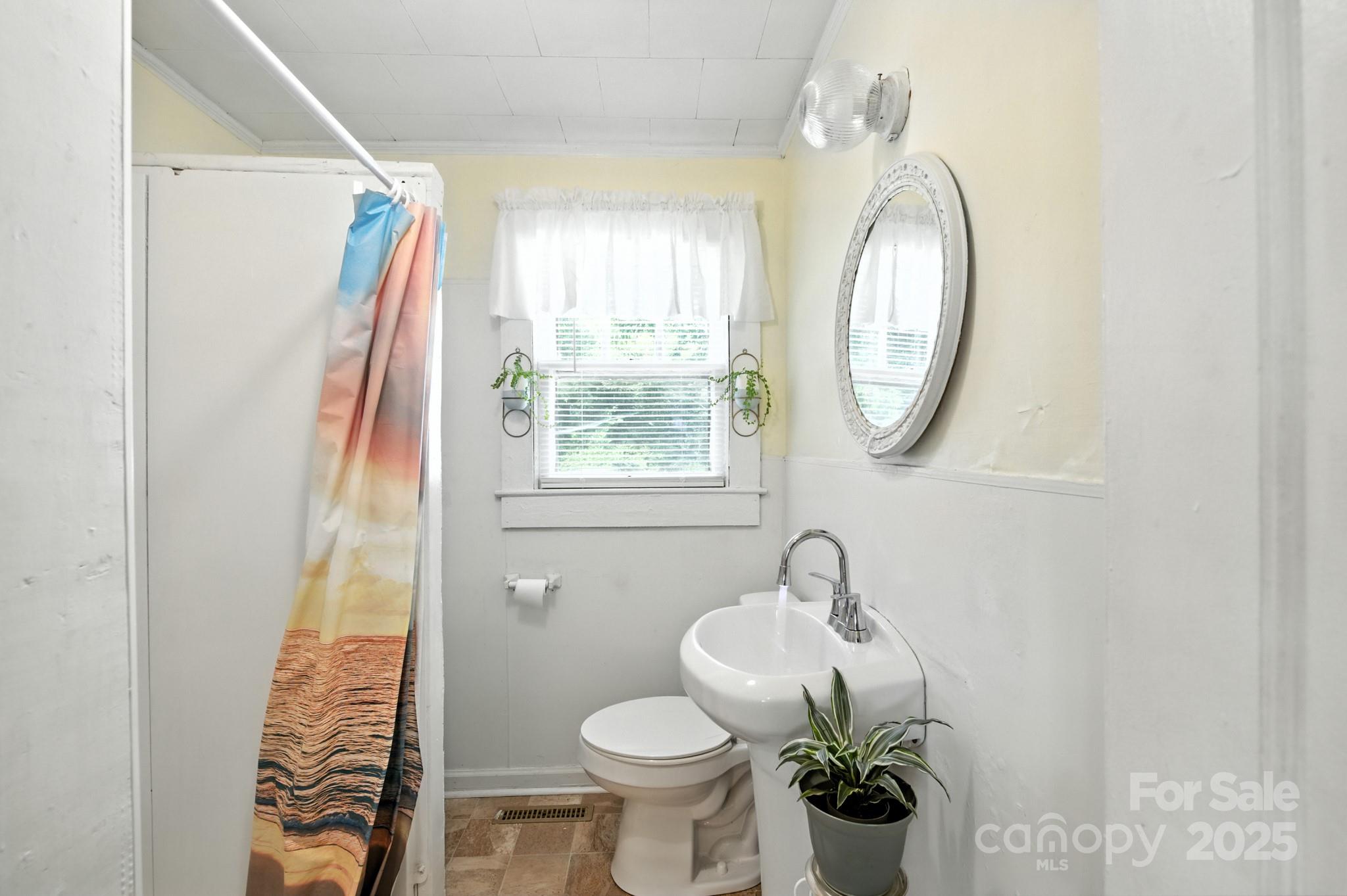 420 Virginia Street Southwest Lenoir, NC 28645 - Photo 25 of 36 a bathroom with a toilet sink and mirror