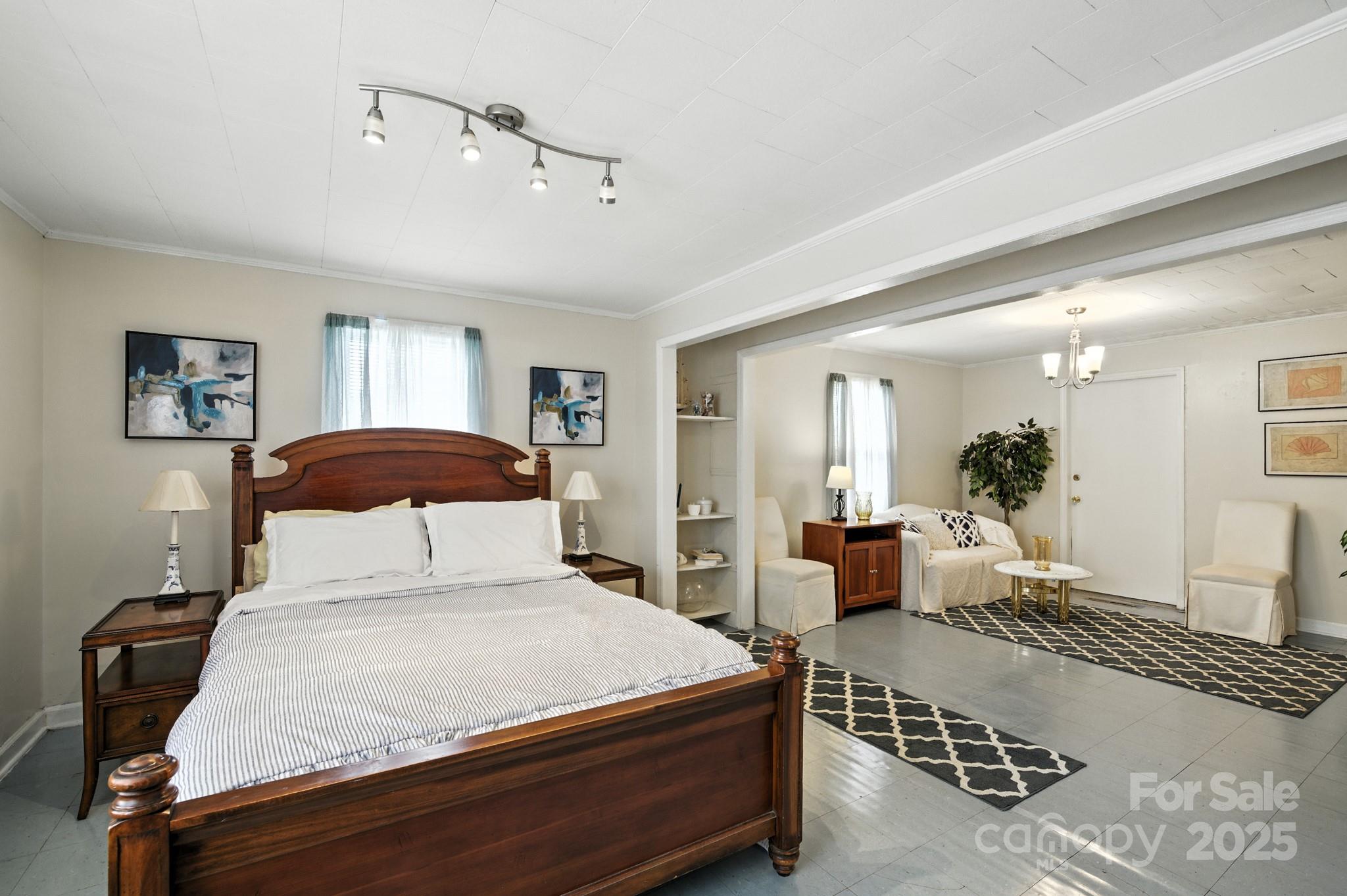 420 Virginia Street Southwest Lenoir, NC 28645 - Photo 26 of 36 a bedroom with a large bed and a chandelier