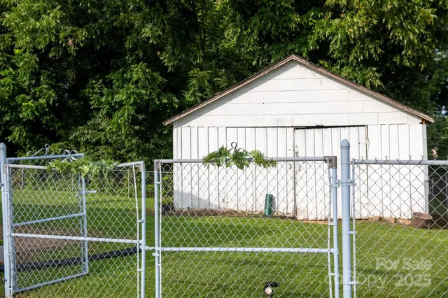 a view of a backyard with wooden fence