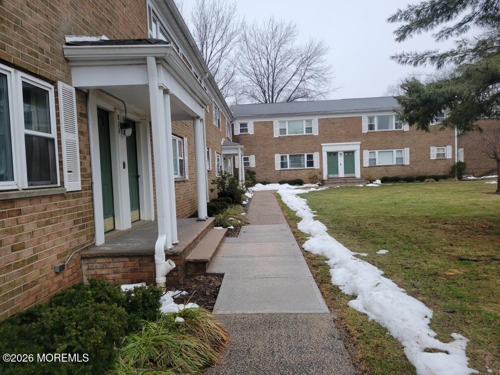 26 Judson Street, Unit 3A Edison, NJ 08837 - Photo 2 of 10 a view of a brick house with many windows next to a yard