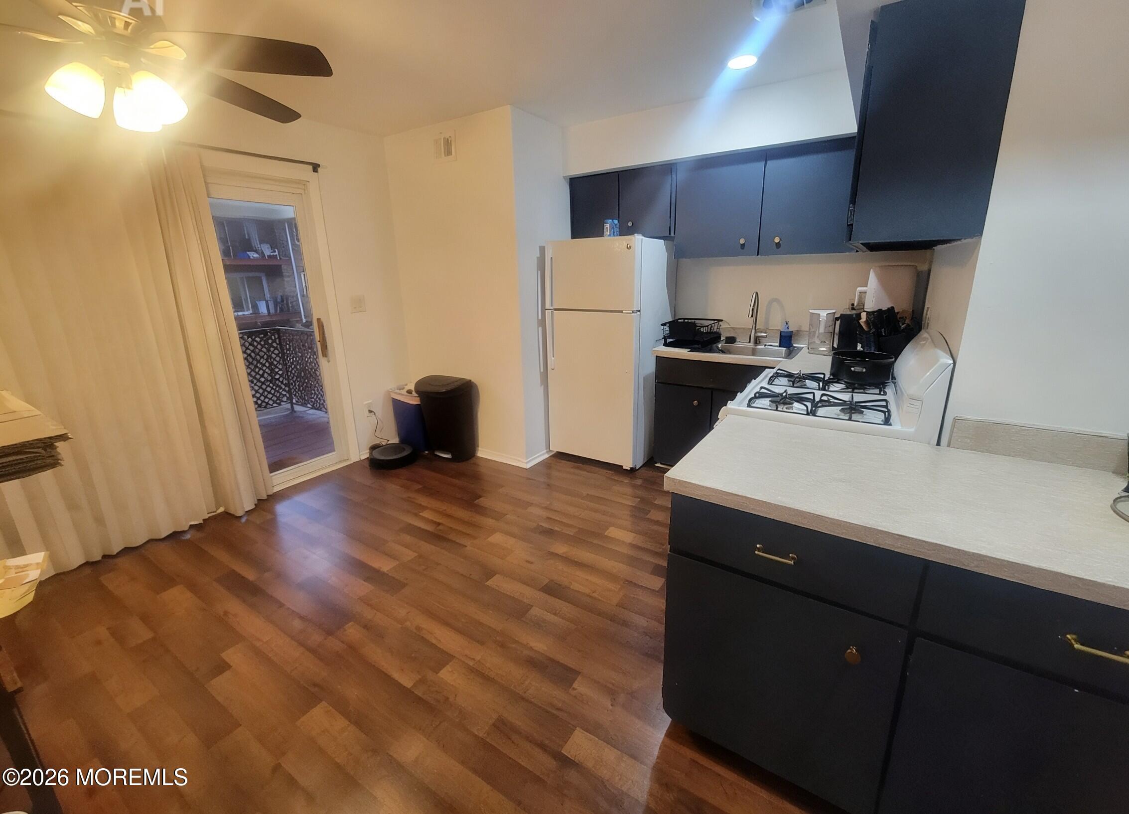 26 Judson Street, Unit 3A Edison, NJ 08837 - Photo 5 of 10 a kitchen with a sink stainless steel appliances a refrigerator and cabinets