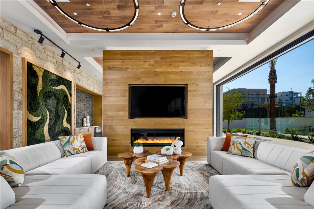 338 Plume Way Montebello, CA 90640 - Photo 19 of 19 a living room with furniture a fireplace and a floor to ceiling window