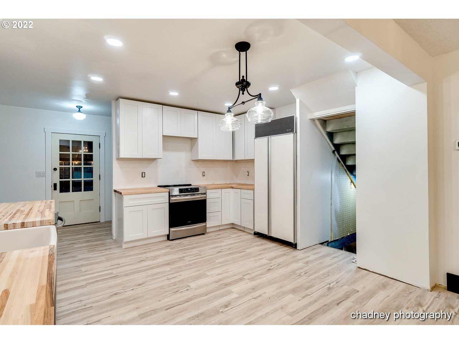 606 Southeast Northway Road Corbett, OR 97019 - Photo 12 of 32 a kitchen with stainless steel appliances kitchen island a refrigerator sink and cabinets