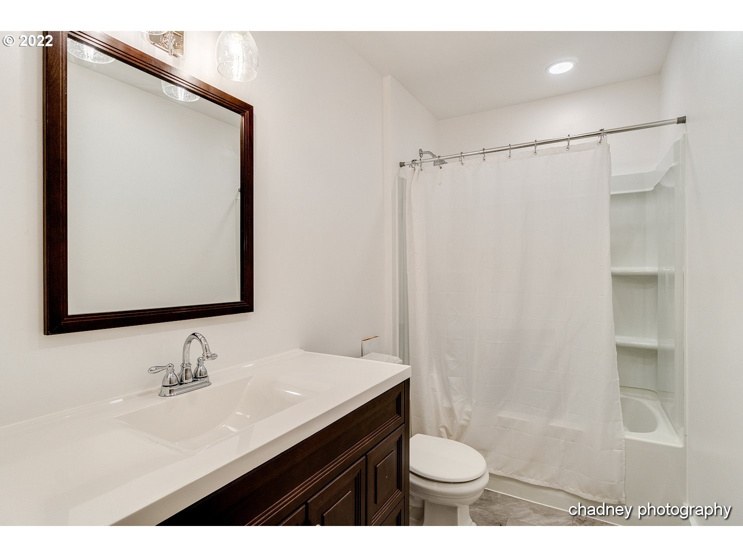606 Southeast Northway Road Corbett, OR 97019 - Photo 14 of 32 a bathroom with a sink a toilet a mirror and shower