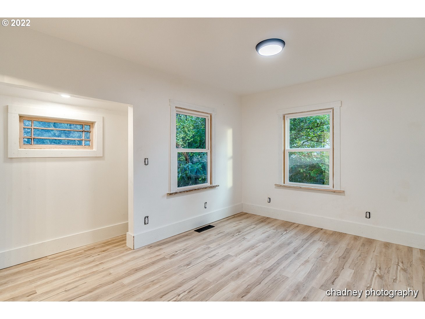 606 Southeast Northway Road Corbett, OR 97019 - Photo 15 of 32 a view of an empty room with wooden floor and a window