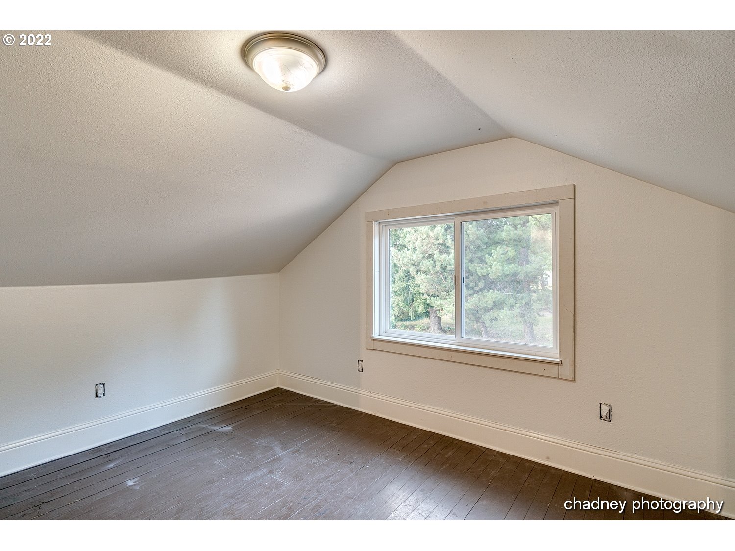 606 Southeast Northway Road Corbett, OR 97019 - Photo 18 of 32 an empty room with wooden floor and windows