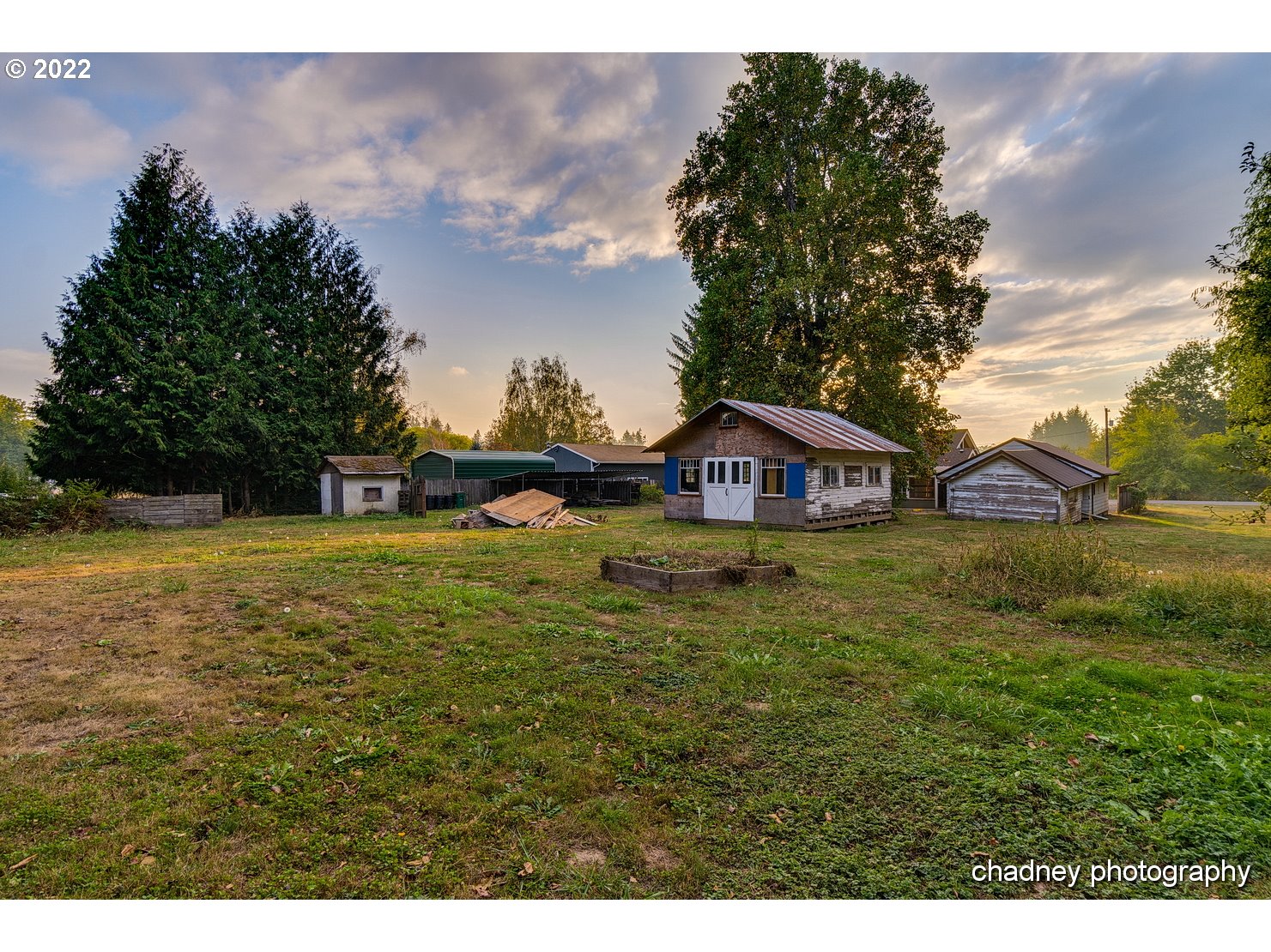 606 Southeast Northway Road Corbett, OR 97019 - Photo 27 of 32 a yellow and red house sitting in the middle of a field