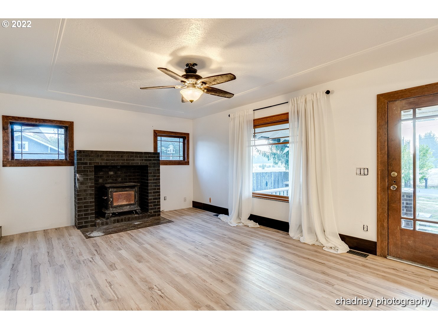 606 Southeast Northway Road Corbett, OR 97019 - Photo 7 of 32 a view of an empty room with a fireplace and a window
