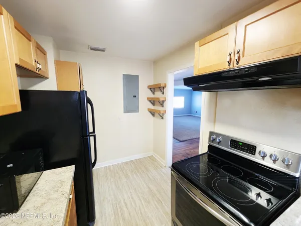 a kitchen with a stove and a microwave