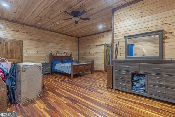 a spacious bedroom with a bed and a table