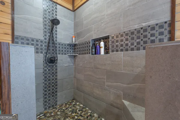 a bathroom with a white bath tub and a shower curtain