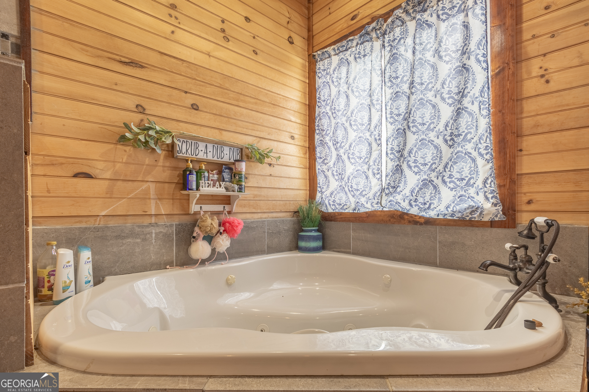 45 J J Davis Road Tallapoosa, GA 30176 - Photo 21 of 24 a bathroom with a white bath tub and a shower curtain