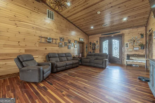 a living room with furniture and wooden floor