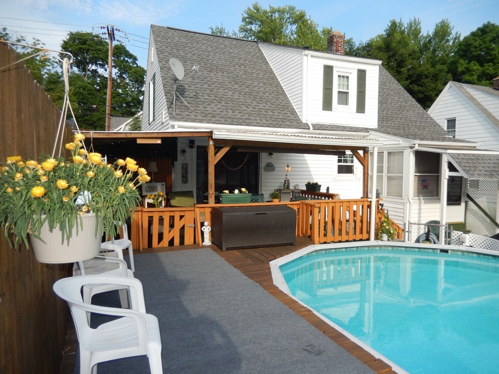 24 Powell Avenue Springfield, MA 01118 - Photo 2 of 30 a view of a patio with couches table and chairs and potted plants
