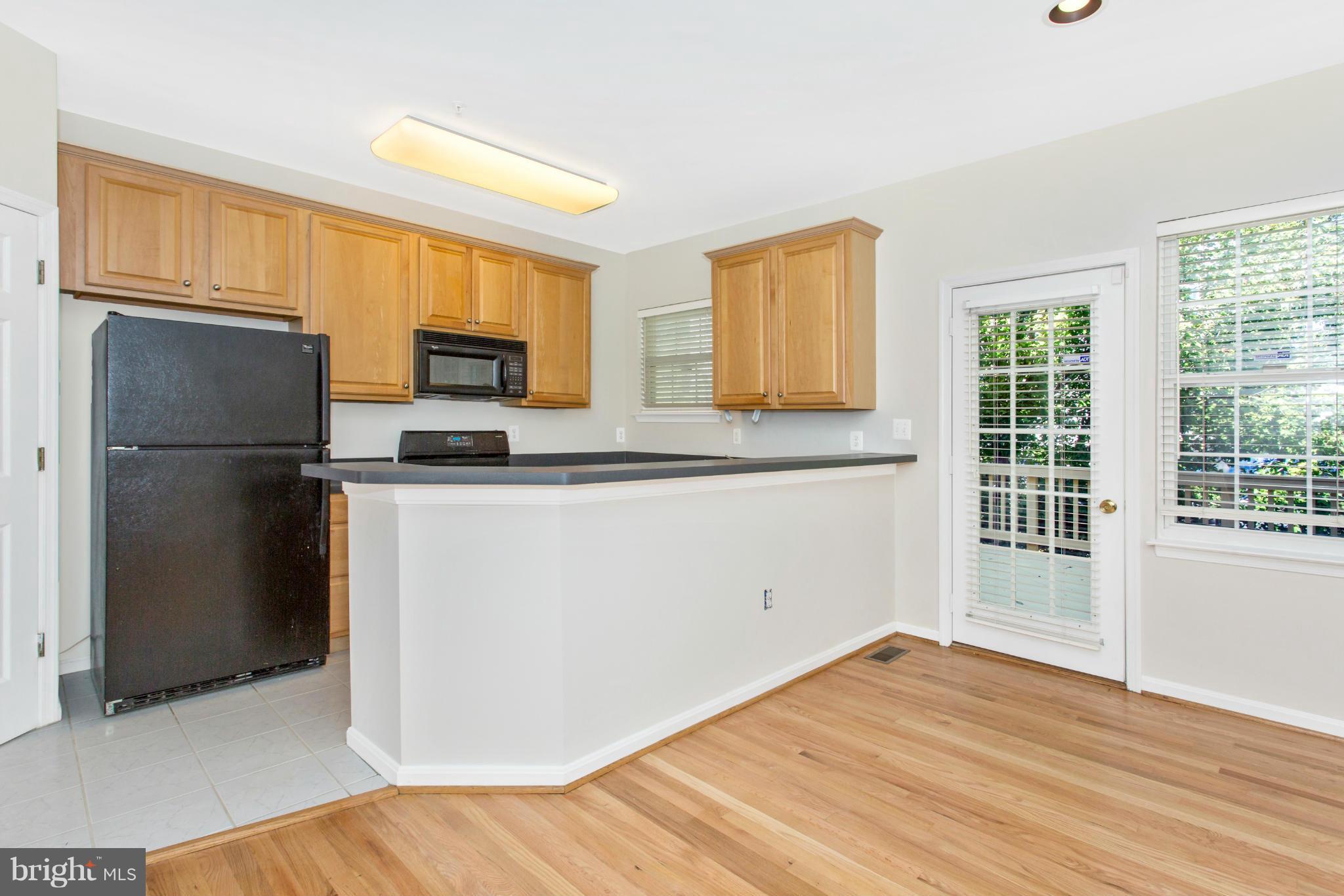 11006 Hemingway Court Silver Spring, MD 20902 - Photo 11 of 30 a kitchen with granite countertop a refrigerator and a sink