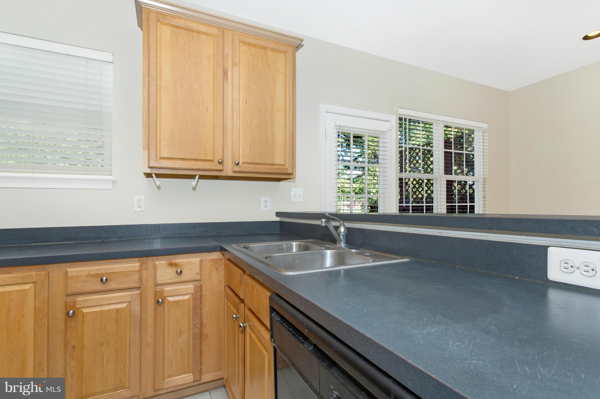 11006 Hemingway Court Silver Spring, MD 20902 - Photo 13 of 30 a kitchen with granite countertop a sink window and cabinets