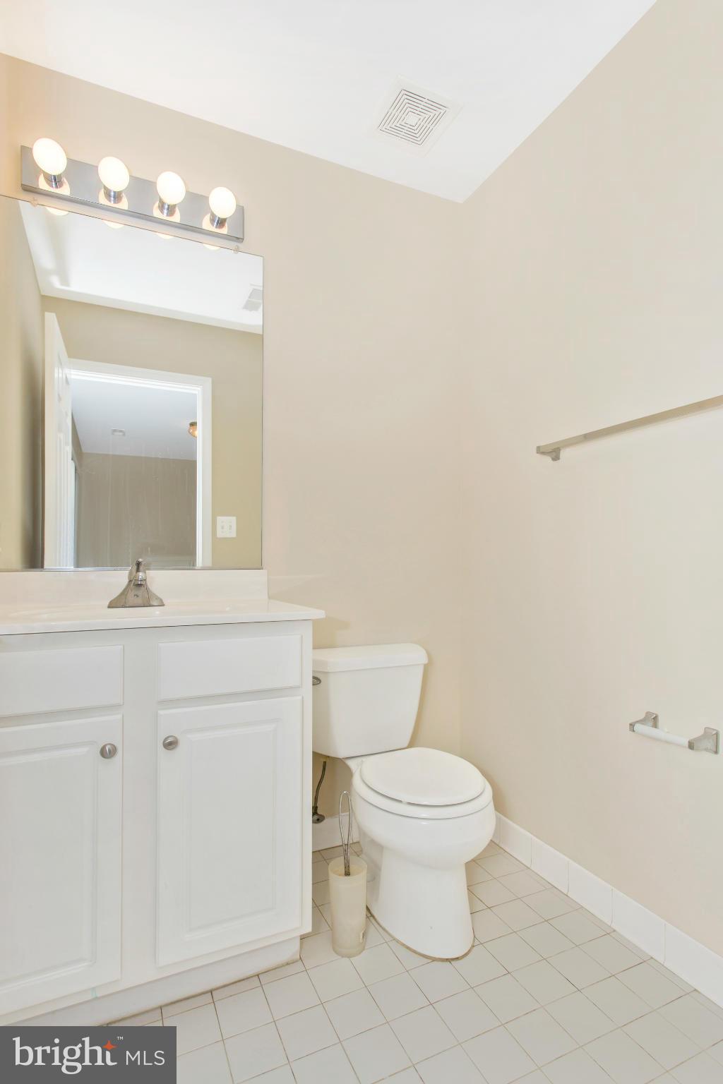 11006 Hemingway Court Silver Spring, MD 20902 - Photo 6 of 30 a bathroom with a toilet a sink and mirror